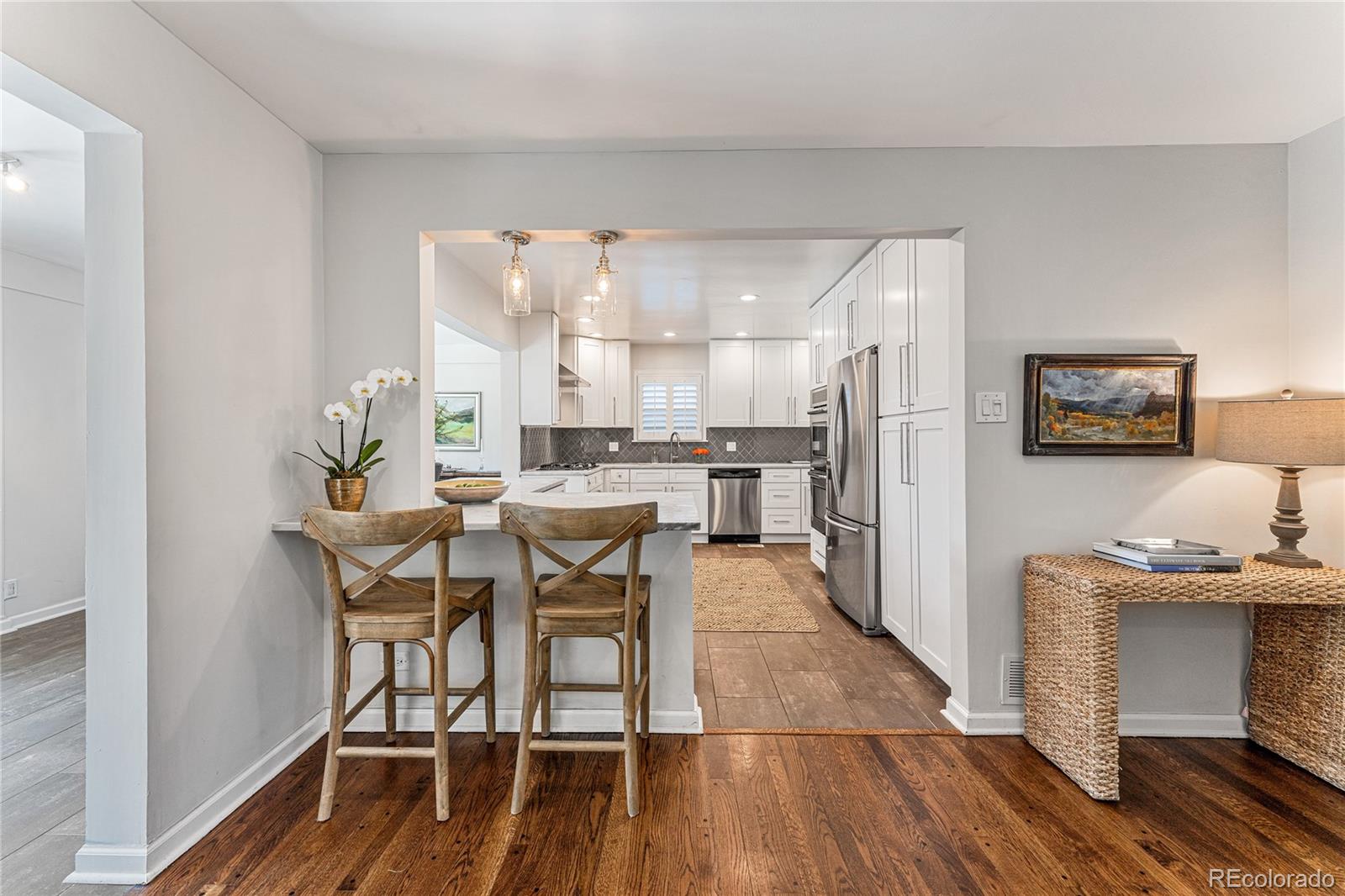 3800 East Dartmouth Avenue Denver, CO 80210 - Photo 9 of 50 a view of a dining room with furniture and wooden floor