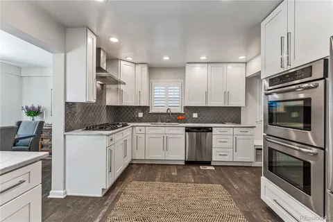 a kitchen with granite countertop stainless steel appliances and cabinets