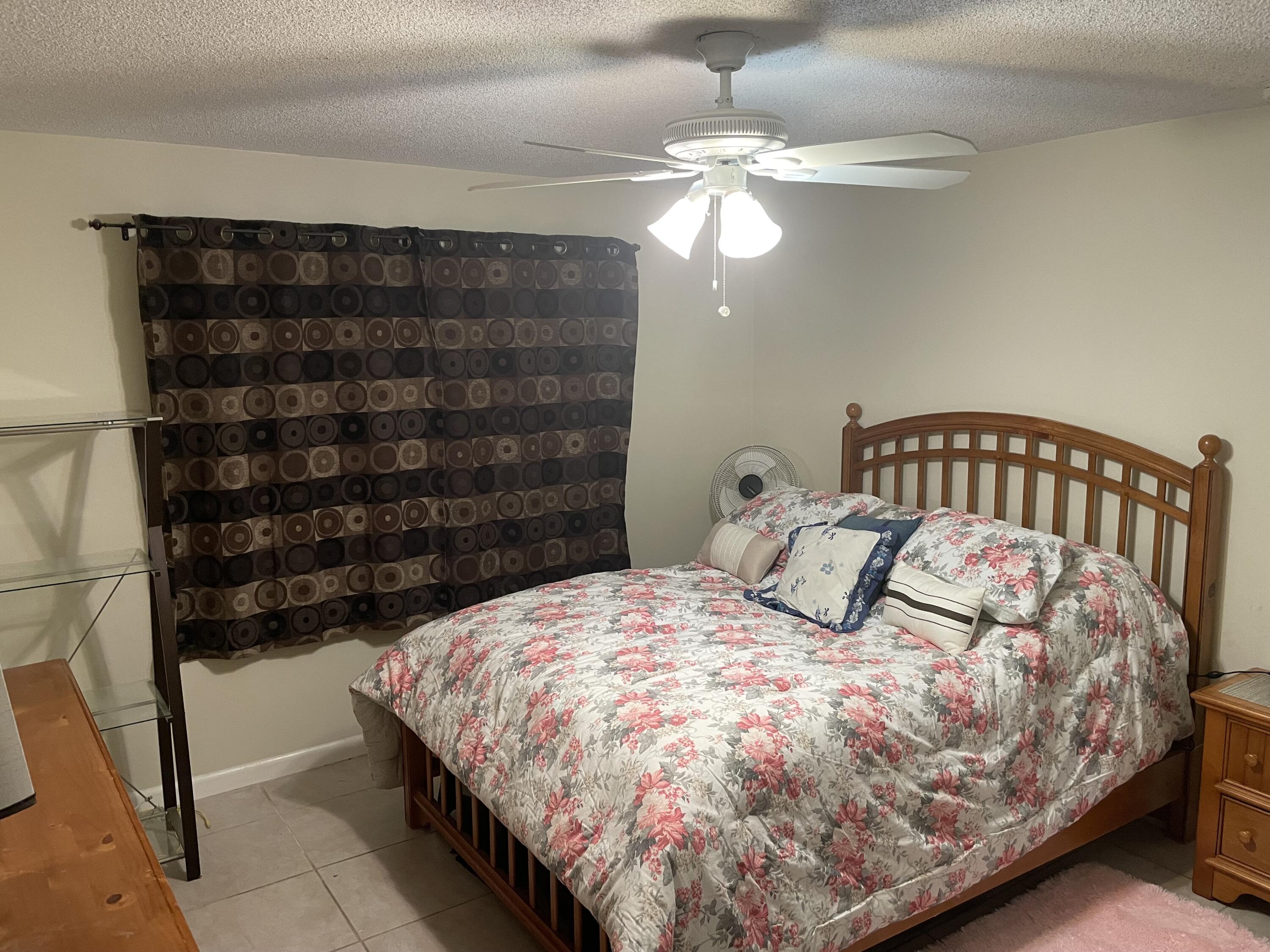 5300 Washington Street, Unit P234 Hollywood, FL 33021 - Photo 12 of 12 a bedroom with a bed and ceiling fan