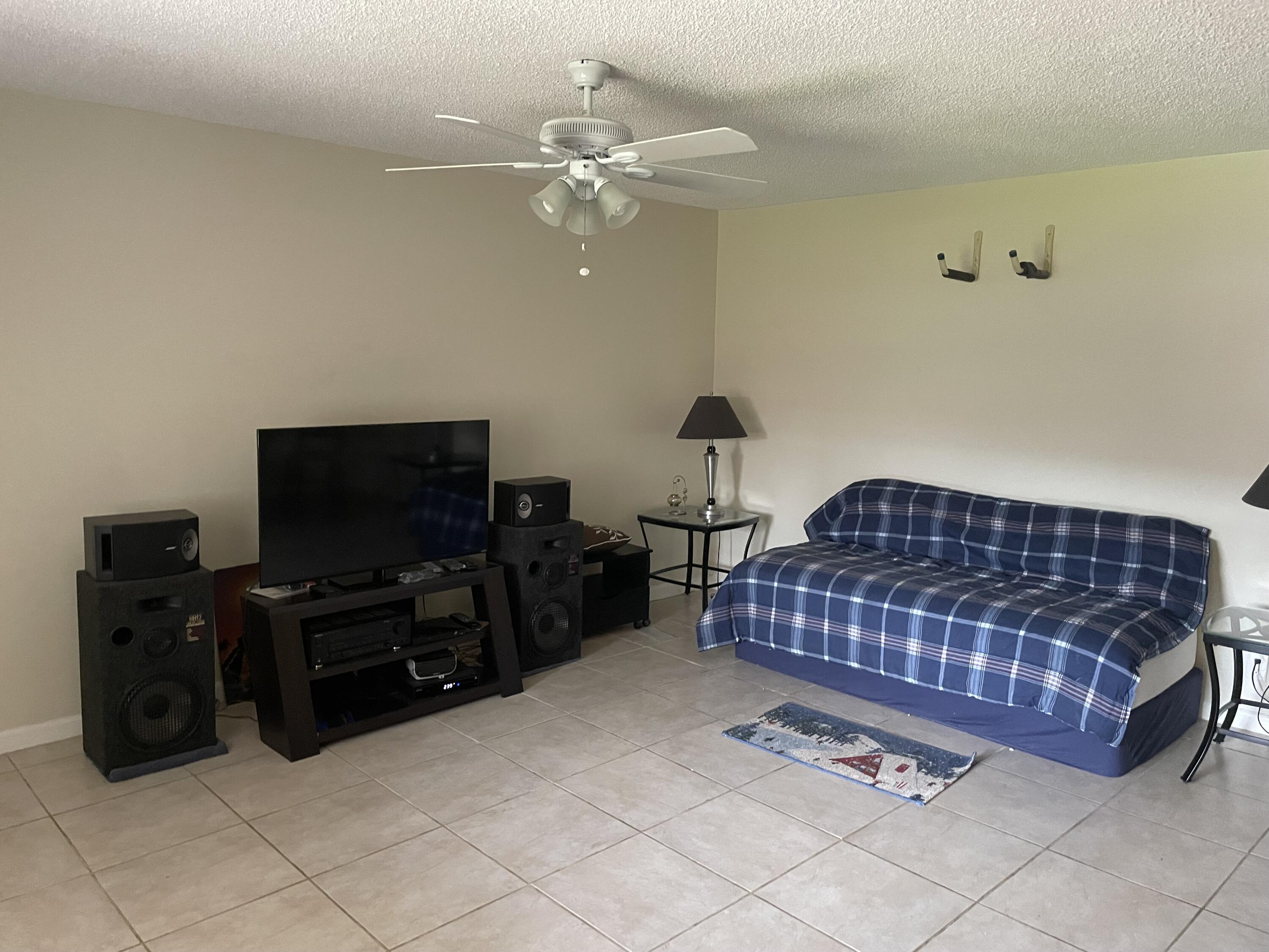 5300 Washington Street, Unit P234 Hollywood, FL 33021 - Photo 5 of 12 a bedroom with a bed and flat screen tv