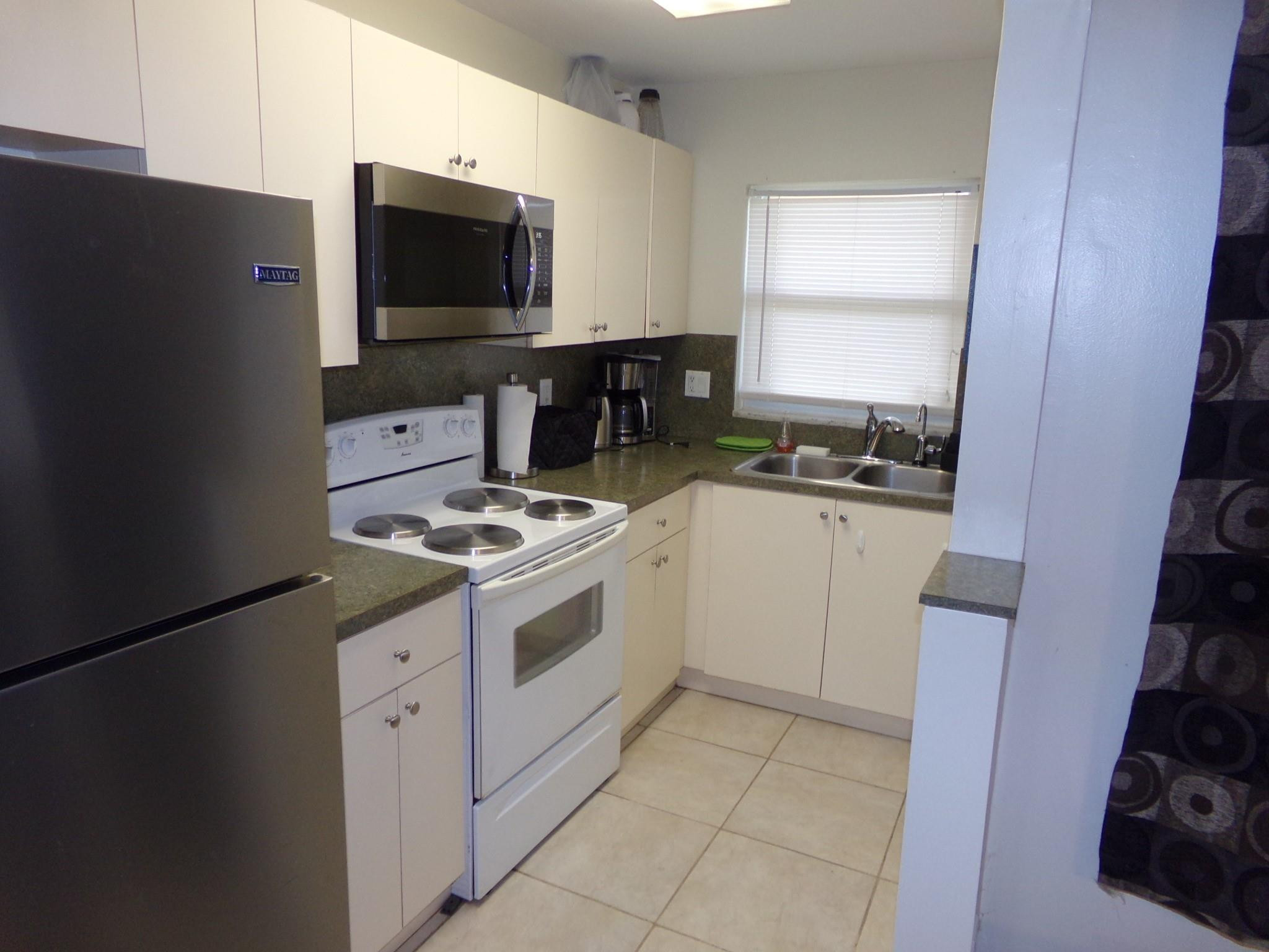 5300 Washington Street, Unit P234 Hollywood, FL 33021 - Photo 6 of 12 a kitchen with a stove and a refrigerator