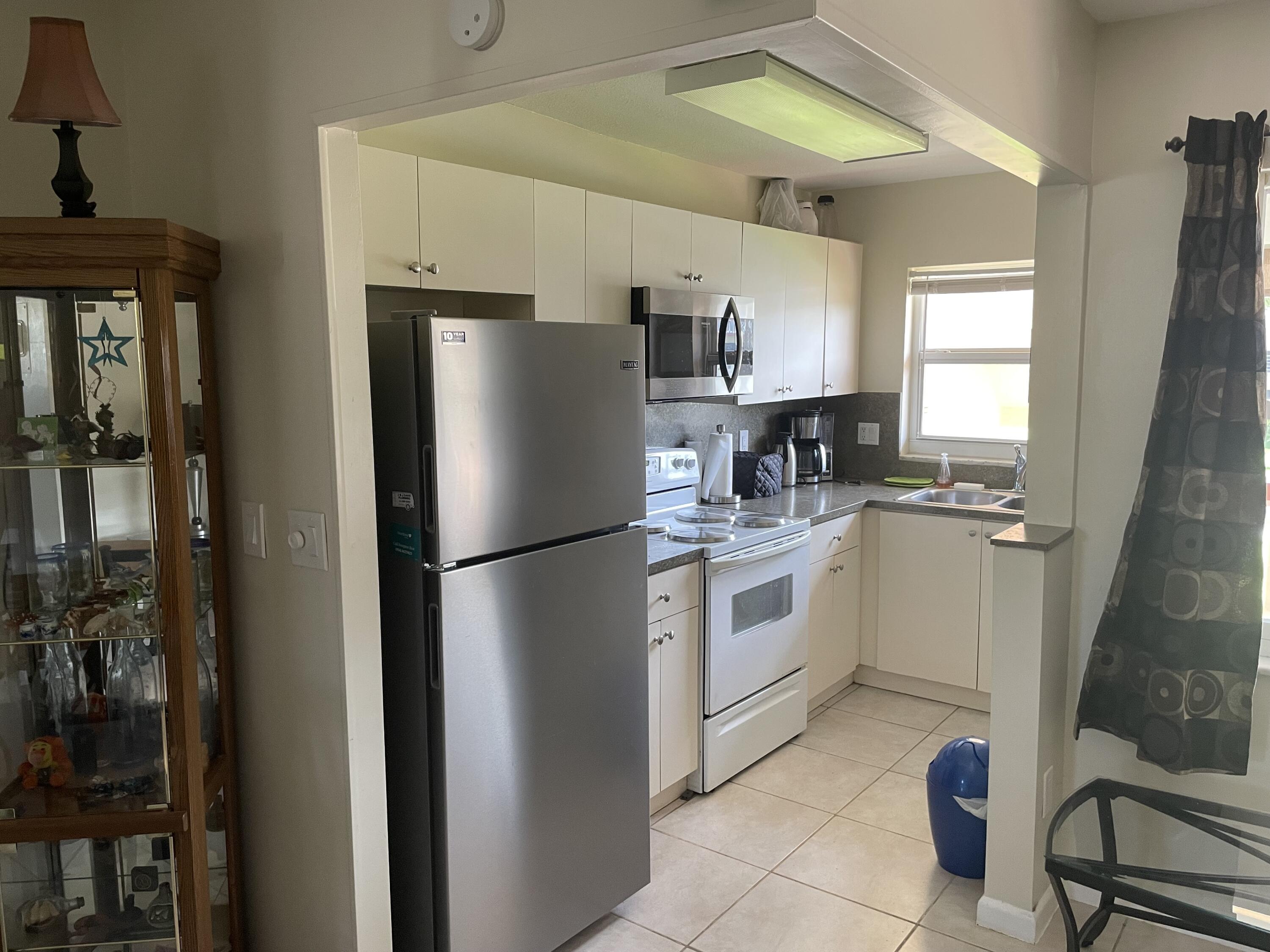 5300 Washington Street, Unit P234 Hollywood, FL 33021 - Photo 7 of 12 a kitchen with a refrigerator sink and cabinets