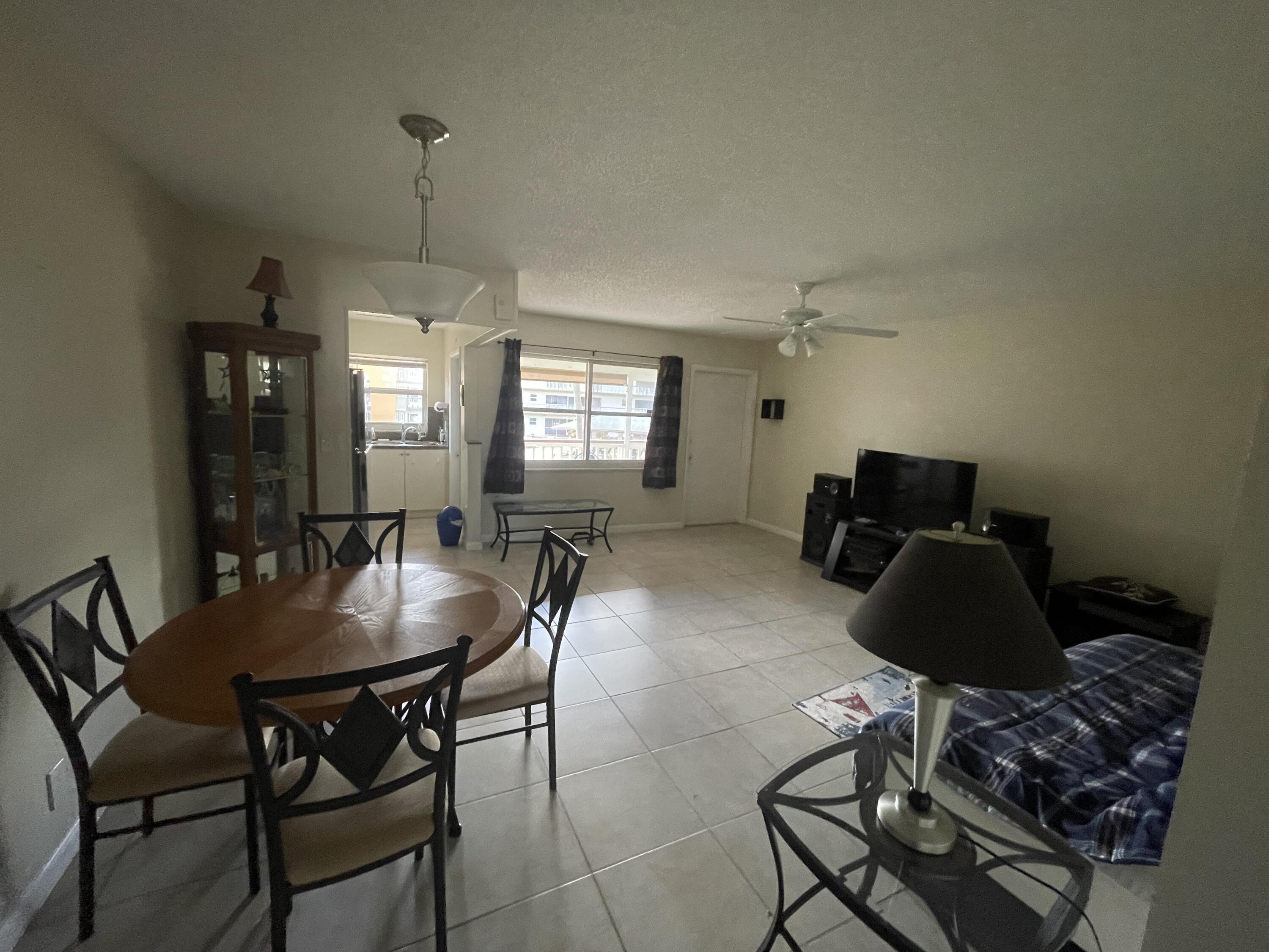 5300 Washington Street, Unit P234 Hollywood, FL 33021 - Photo 8 of 12 a dining room with furniture and window