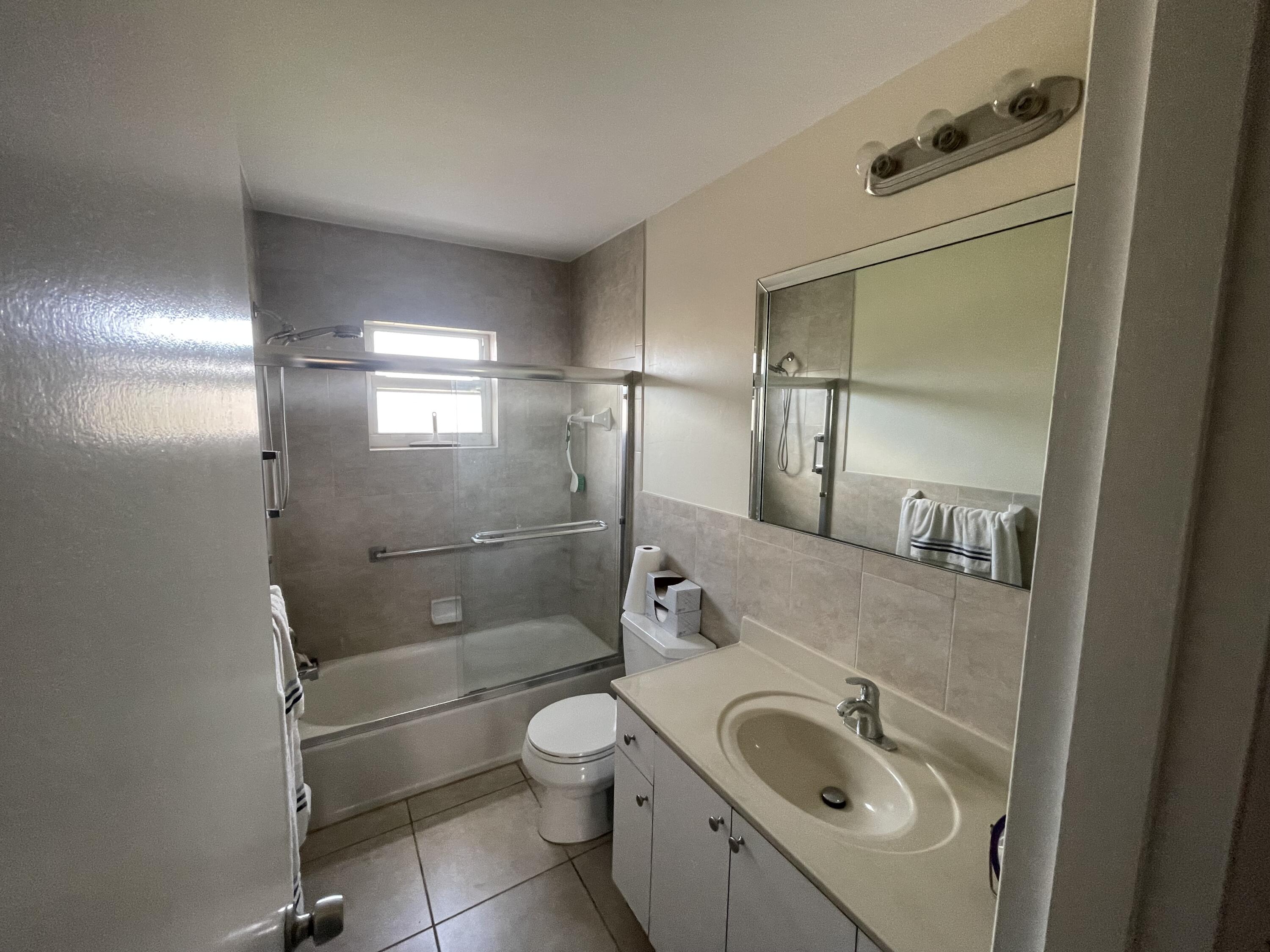 5300 Washington Street, Unit P234 Hollywood, FL 33021 - Photo 10 of 12 a bathroom with a granite countertop sink toilet and shower