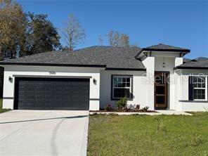 5981 Southwest 154th Place Ocala, FL 34473 - Photo 1 of 18 front view of a house with a yard