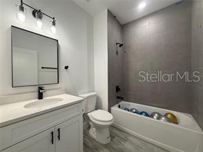 5981 Southwest 154th Place Ocala, FL 34473 - Photo 13 of 18 a bathroom with a sink a toilet and a mirror