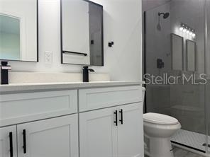 5981 Southwest 154th Place Ocala, FL 34473 - Photo 17 of 18 a bathroom with a sink a toilet and mirror