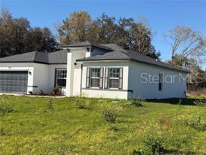 5981 Southwest 154th Place Ocala, FL 34473 - Photo 2 of 18 a view of a house with a yard