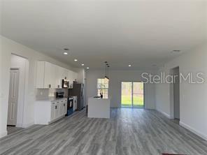 5981 Southwest 154th Place Ocala, FL 34473 - Photo 4 of 18 a view of a kitchen with a sink and a refrigerator