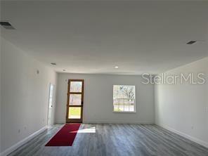 5981 Southwest 154th Place Ocala, FL 34473 - Photo 5 of 18 an empty room with windows and cabinet