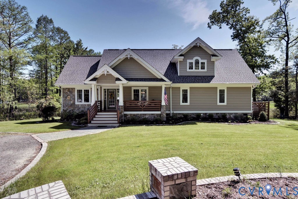 a front view of a house with a garden and trees
