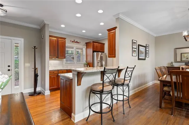 a dining room with furniture and wooden floor