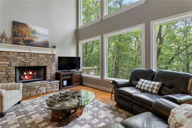 a living room with furniture a flat screen tv and a fireplace