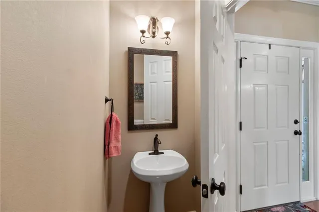 a bathroom with a sink mirror and vanity