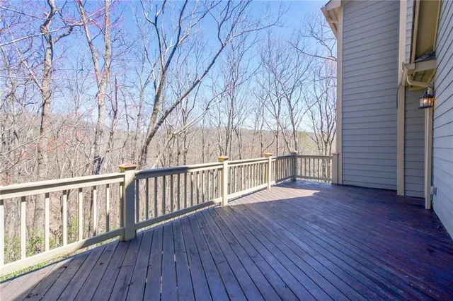 a view of wooden deck and a backyard