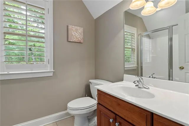 a view of a hallway to a livingroom with furniture and windows