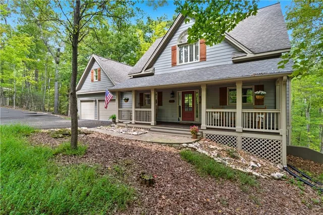 a view of a house with a yard and wooden fence
