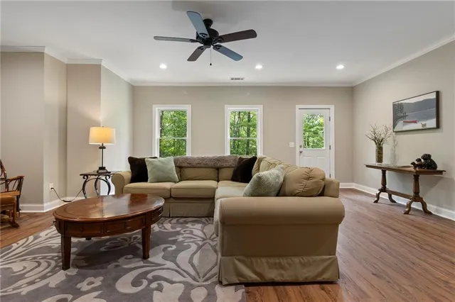 a living room with furniture and a wooden floor