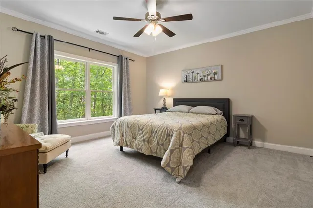 a bathroom with a granite countertop toilet sink and mirror