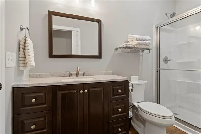 a roof deck with couches and wooden fence