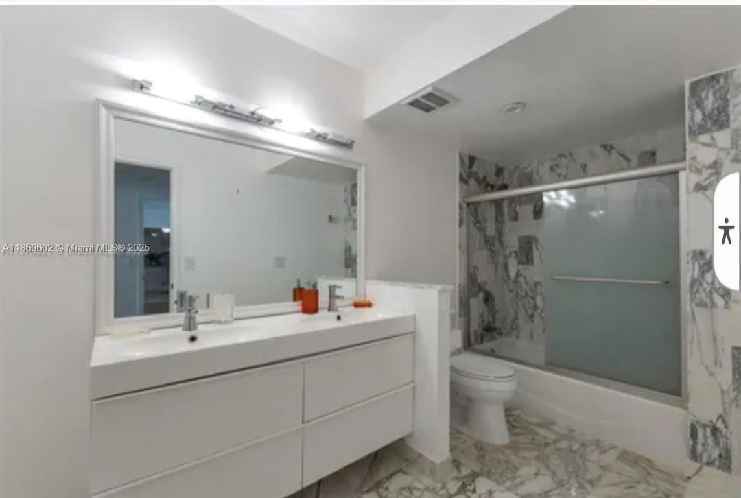 9801 Collins Avenue, Unit 10T Bal Harbour, FL 33154 - Photo 11 of 20 a bathroom with a sink toilet and shower