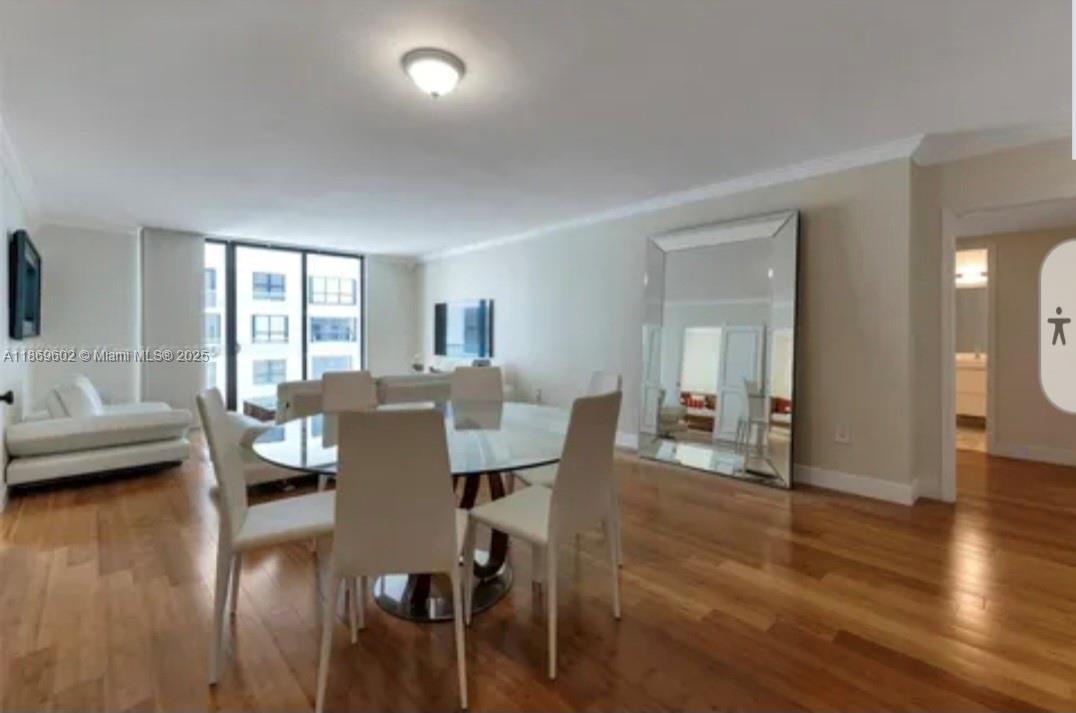 9801 Collins Avenue, Unit 10T Bal Harbour, FL 33154 - Photo 2 of 20 a dining room with furniture and wooden floor