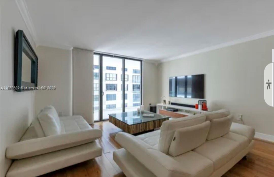 9801 Collins Avenue, Unit 10T Bal Harbour, FL 33154 - Photo 5 of 20 a living room with furniture and a flat screen tv