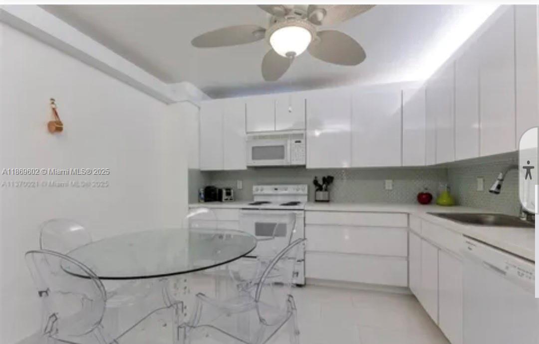 9801 Collins Avenue, Unit 10T Bal Harbour, FL 33154 - Photo 7 of 20 a kitchen with a sink cabinets and window