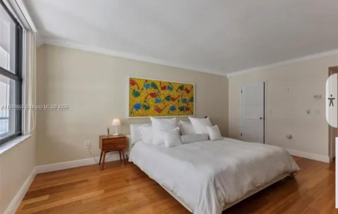 9801 Collins Avenue, Unit 10T Bal Harbour, FL 33154 - Photo 8 of 20 a bedroom with a bed and a wall painting