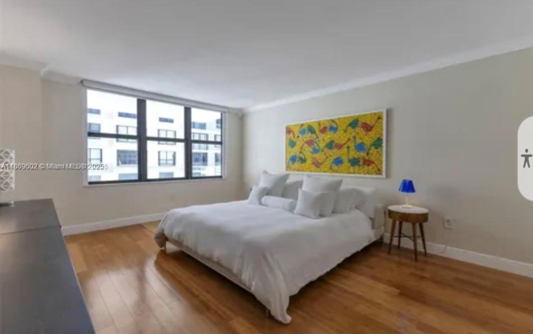 9801 Collins Avenue, Unit 10T Bal Harbour, FL 33154 - Photo 9 of 20 a bedroom with a bed and a painting on the wall