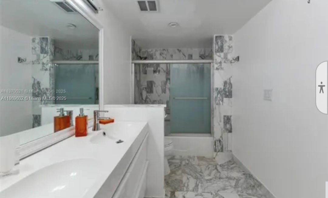 9801 Collins Avenue, Unit 10T Bal Harbour, FL 33154 - Photo 10 of 20 a bathroom with a tub sink and shower