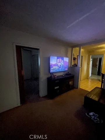 a kitchen with a stove a sink a microwave and a refrigerator