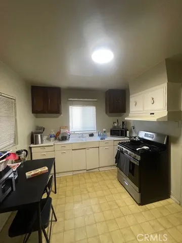 a bedroom with a bed and a tv on the dresser