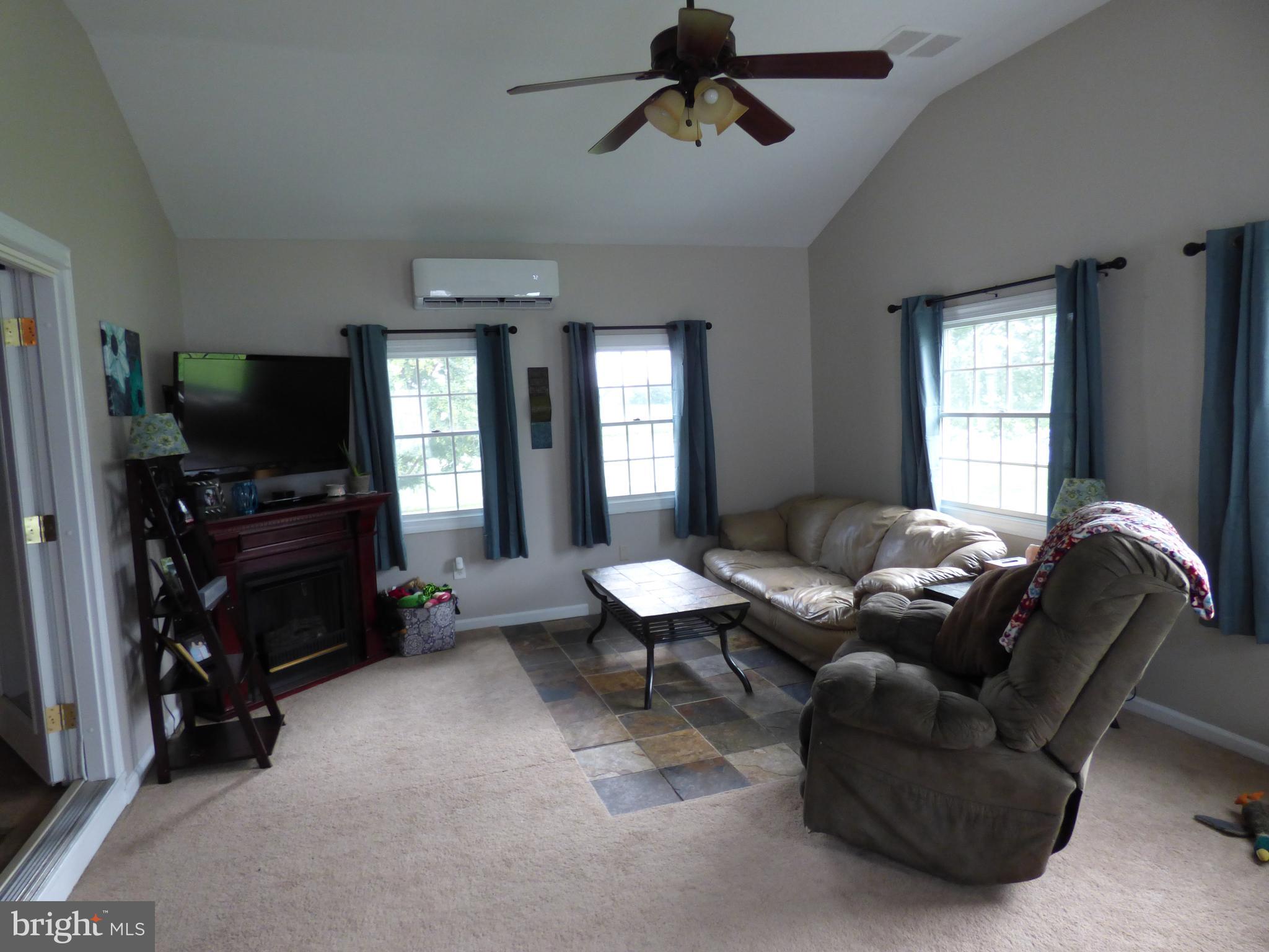 36133 Poplar Neck Road Willards, MD 21874 - Photo 22 of 33 a living room with furniture and a flat screen tv