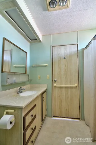 a bathroom with a sink a mirror and a shower