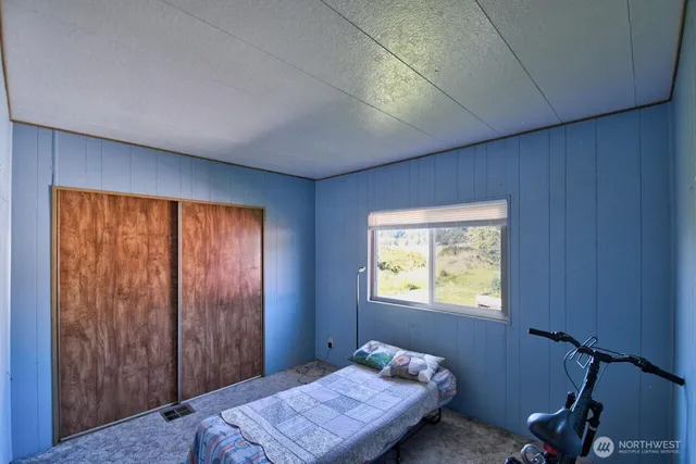 a bedroom with a bed and a window