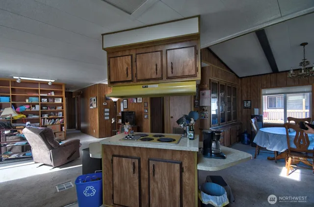 a living room with furniture a fireplace and a large window