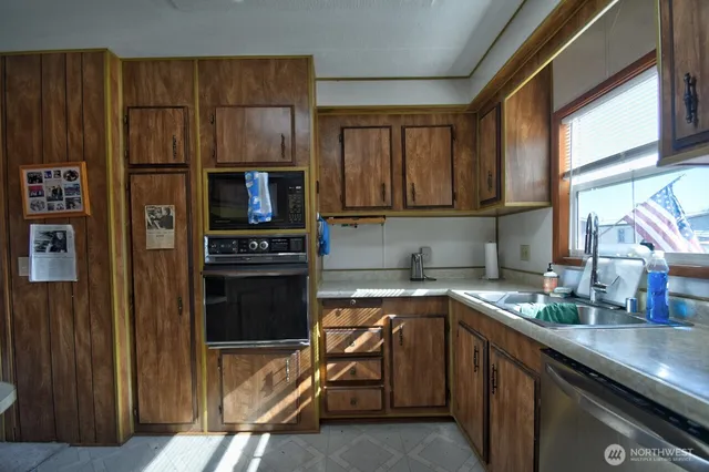 a kitchen with a sink appliances and cabinets