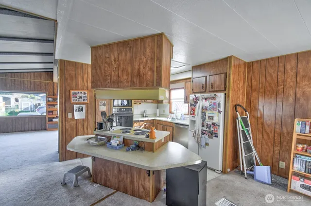 a view of a dining room with furniture and a window