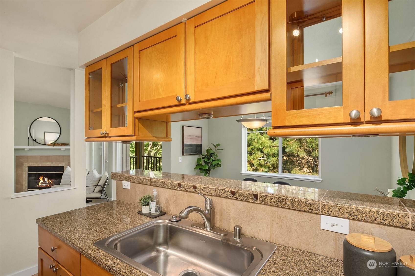18930 Bothell Everett Highway, Unit D302 Bothell, WA 98012 - Photo 13 of 25 a kitchen with granite countertop a sink and a wooden floor