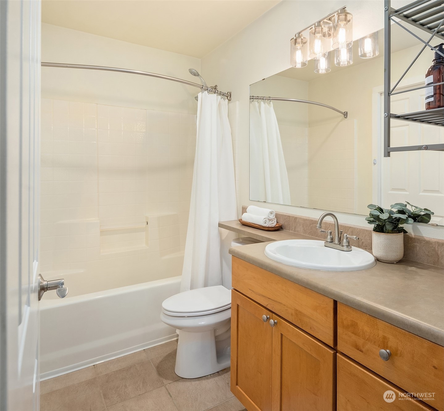 18930 Bothell Everett Highway, Unit D302 Bothell, WA 98012 - Photo 20 of 25 a bathroom with a sink a toilet and shower