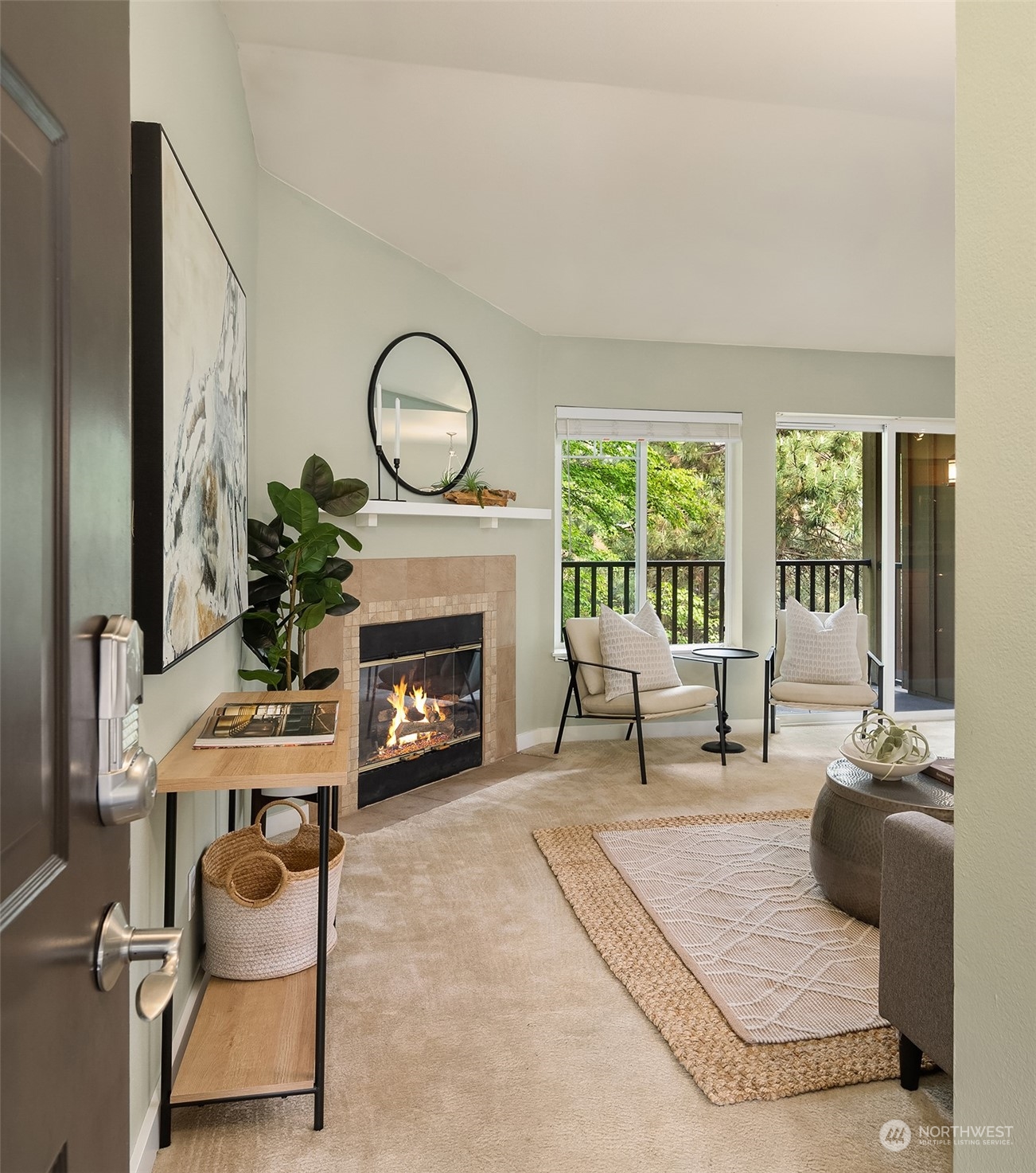 18930 Bothell Everett Highway, Unit D302 Bothell, WA 98012 - Photo 2 of 25 a living room with furniture a fireplace and floor to ceiling window