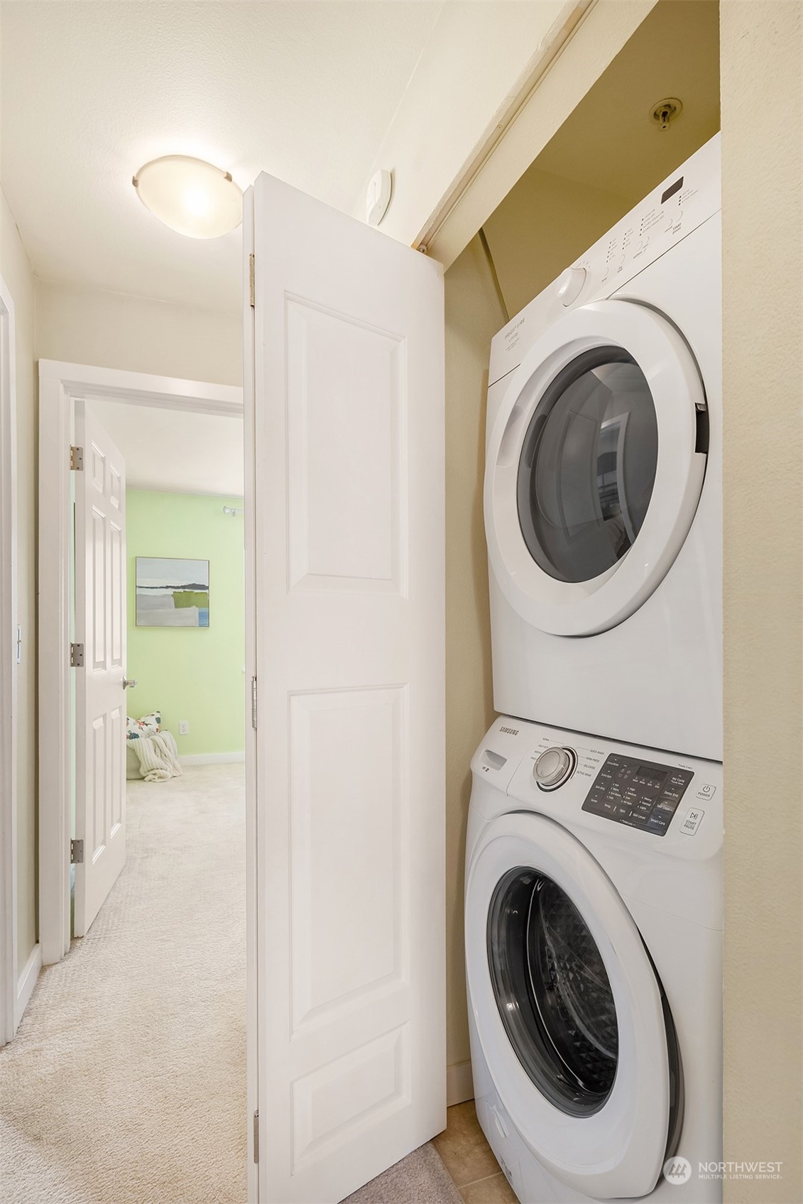 18930 Bothell Everett Highway, Unit D302 Bothell, WA 98012 - Photo 22 of 25 a view of a hallway with washer and dryer