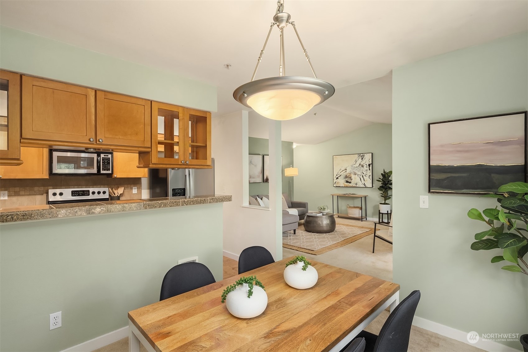 18930 Bothell Everett Highway, Unit D302 Bothell, WA 98012 - Photo 9 of 25 a view of a dining room with furniture and wooden floor