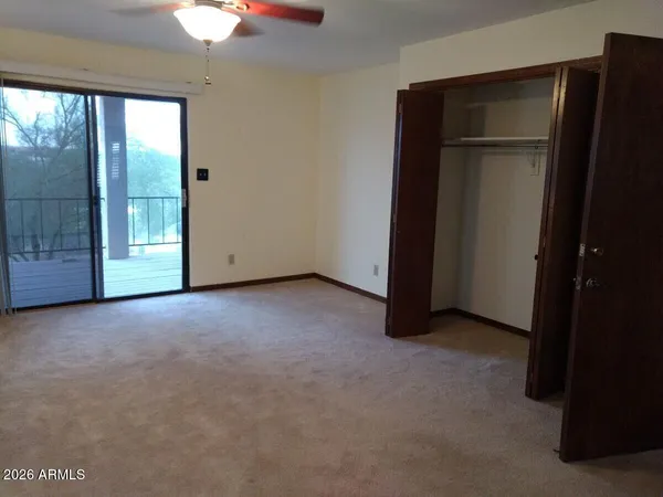 an empty room with a empty space and a ceiling fan