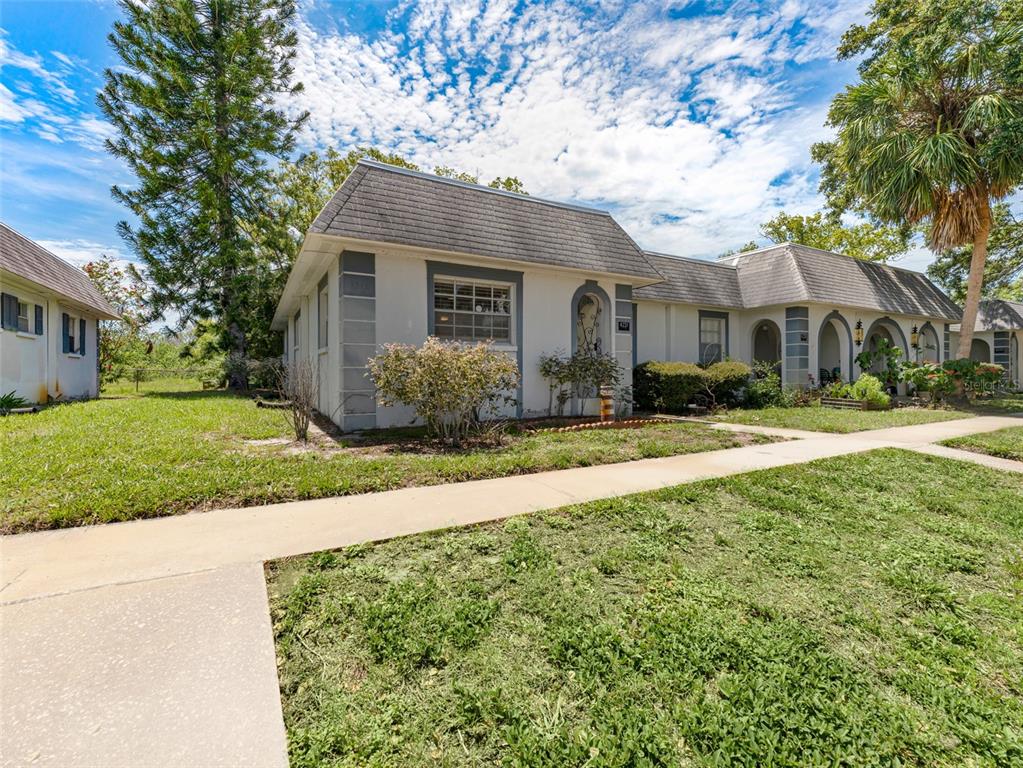 a front view of house with yard and green space