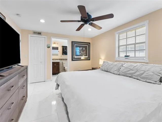 a bedroom with a large bed and a flat screen tv