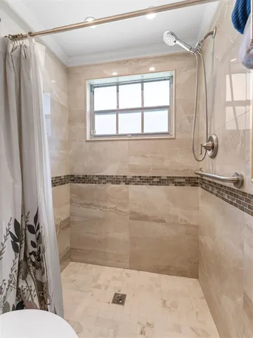 a bathroom with a bathtub and a shower