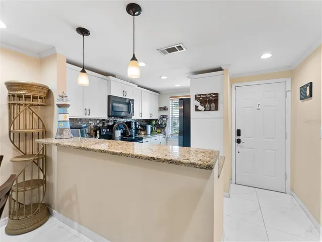 a view of a kitchen with stainless steel appliances granite countertop cabinets and a wooden floor