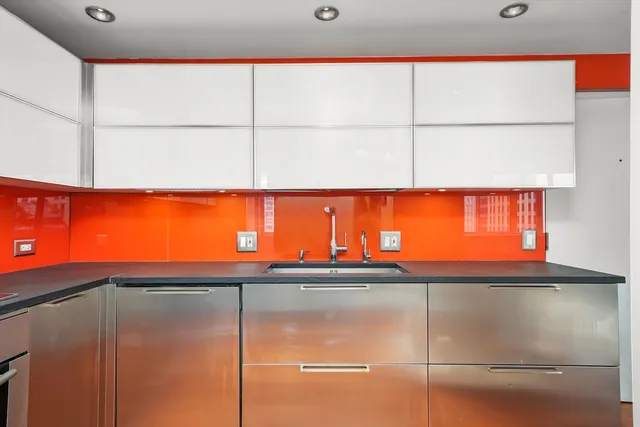 a view of kitchen with stove and cabinets